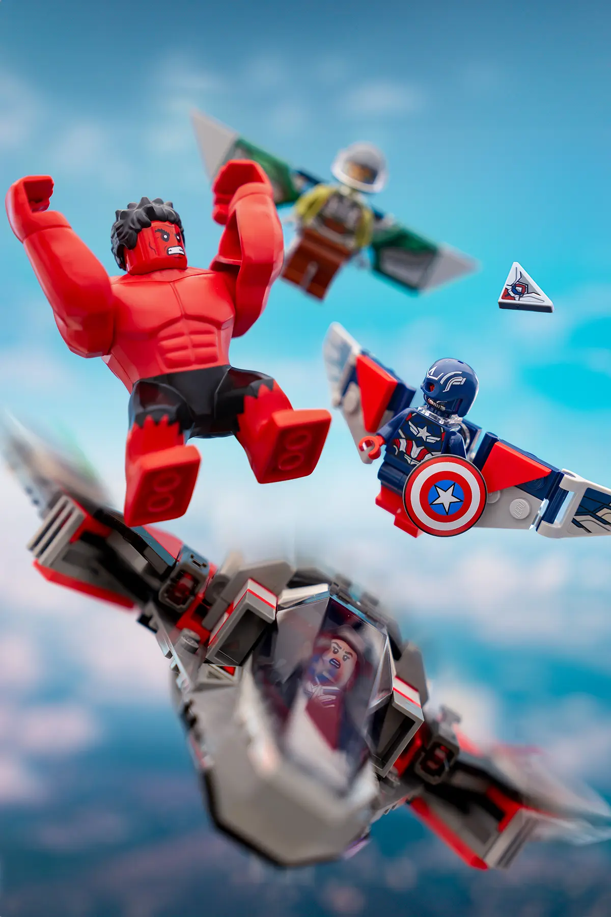 Red Hulk and Sam Wilson Captain America soar through a bright sky in an intense LEGO aerial battle. Support bars have been removed, and the image is sharpened with vibrant lighting and motion details for added realism.